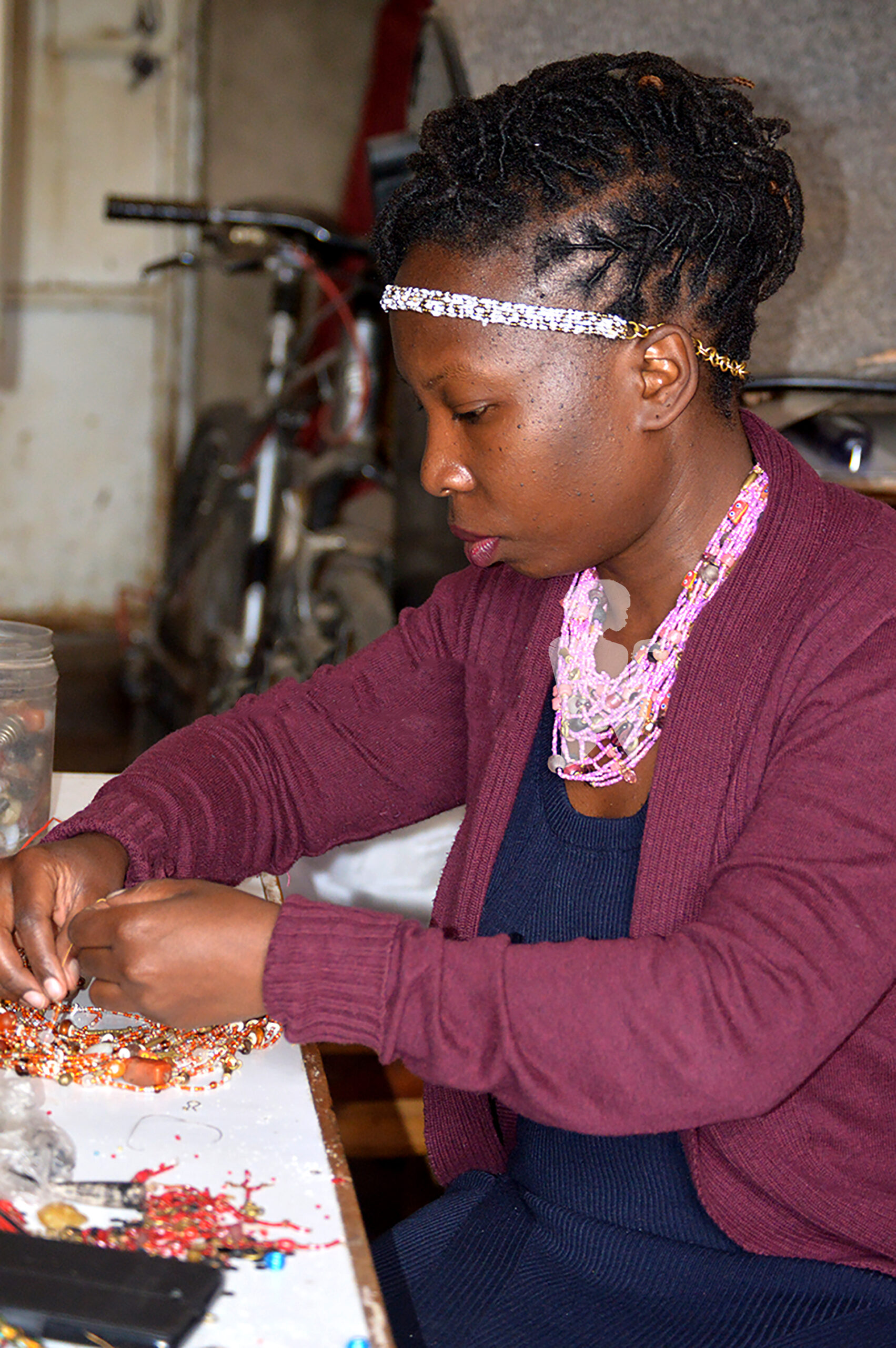 Lucille Lukagwa being creative with the beads